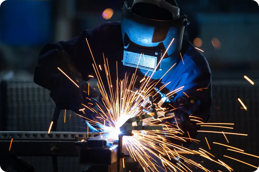 Industrial welder at work with bright sparks
